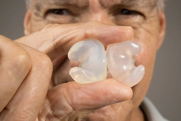 old man showing his earmoulds